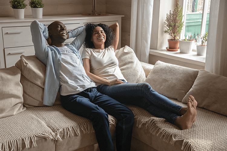 Couple relaxing on their couch in the living room