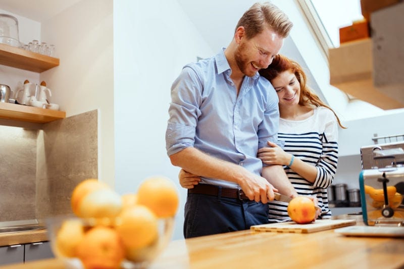 Happy couple making organic juice